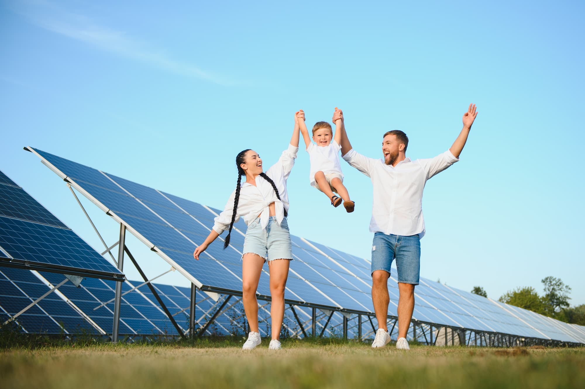 Family beside Big solar panel Plant